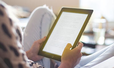 Woman reading a glowing eBook